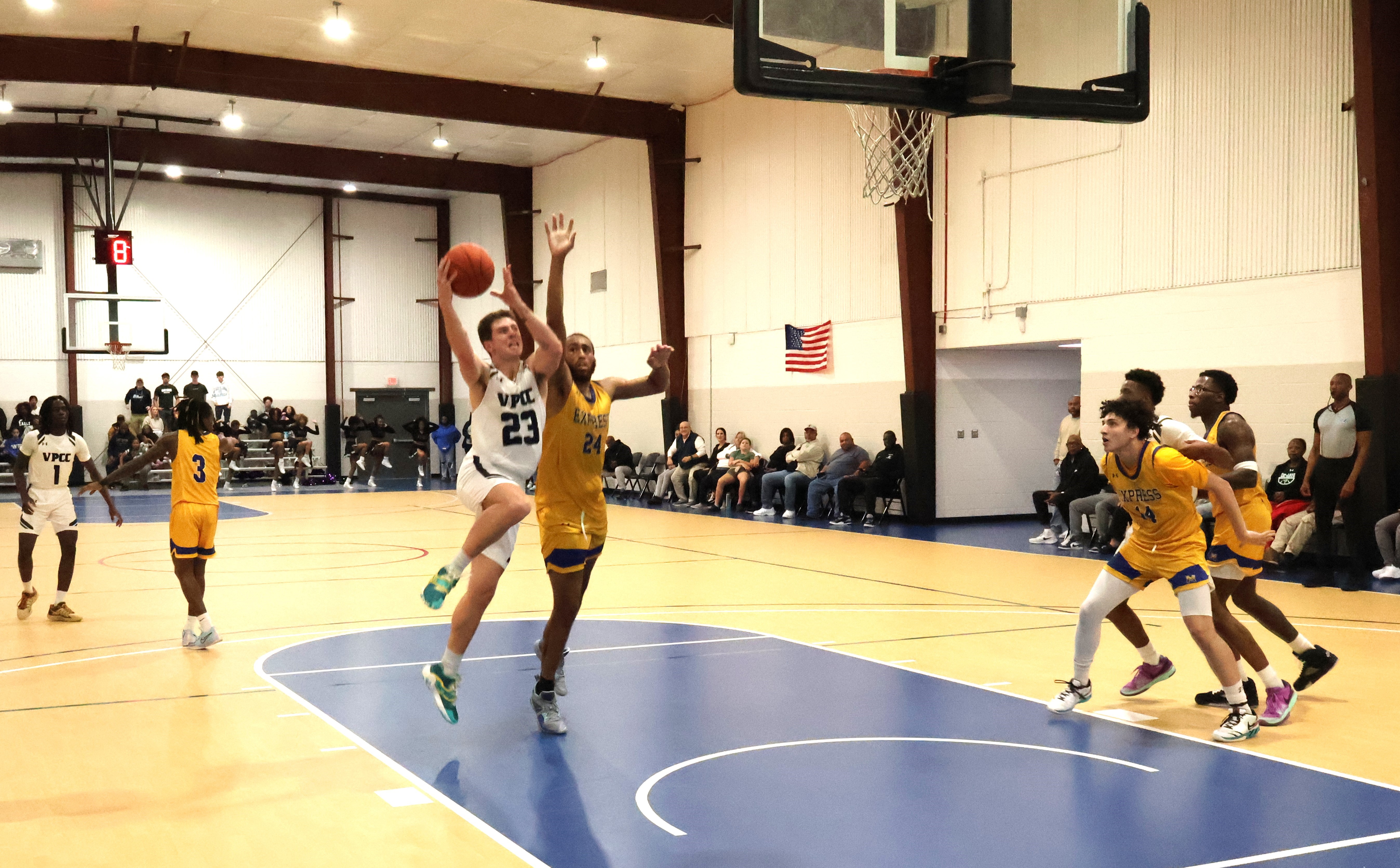 Asa Fehrenbach drives to the basket against Monroe College of the Bronx.