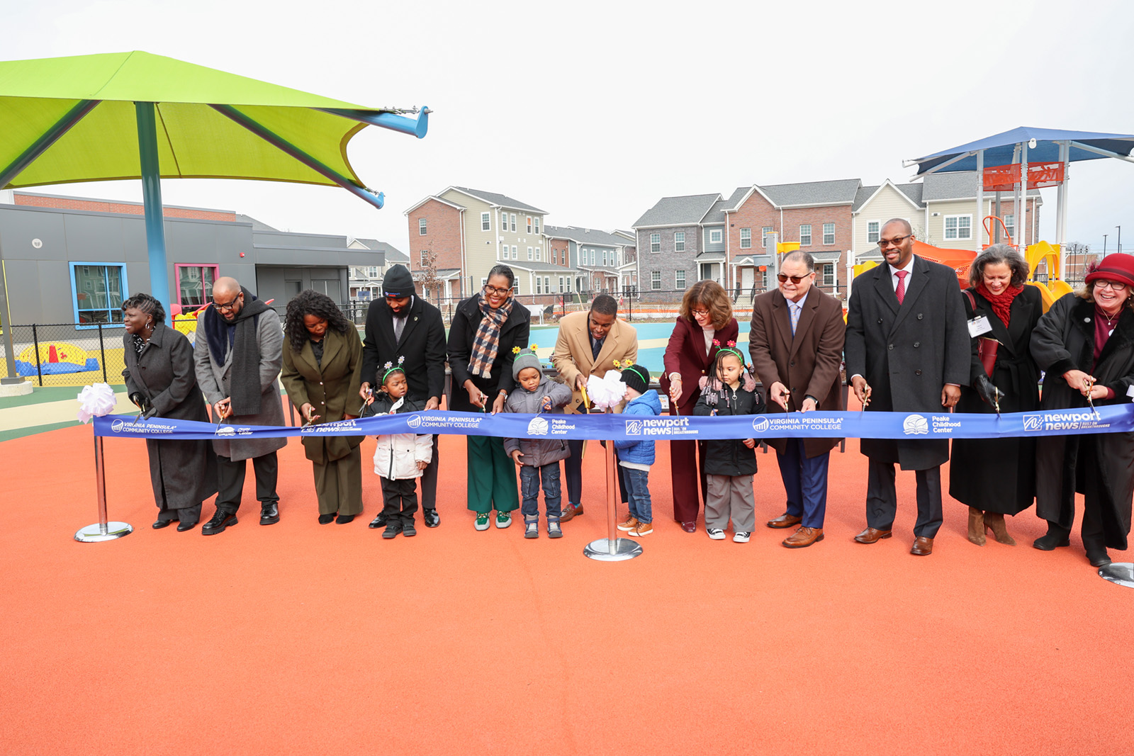 VPCC President Dr. Towuanna Porter Brannon (in scarf) joined Newport News dignitaries, officials from the Peake Childhood Center and children in cutting the ribbon for the Newport News Early Childhood Development Center.